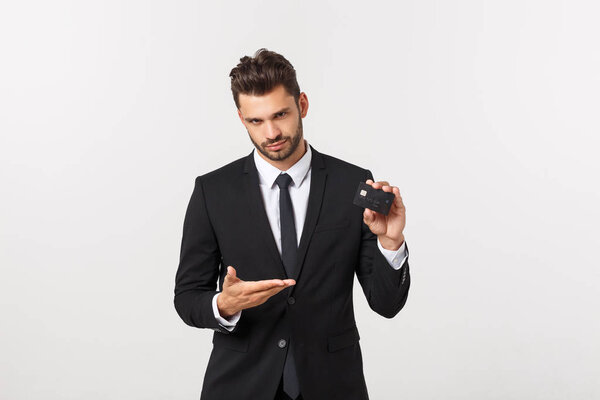 Surprised, speechless and impressed handsome caucasian businessman in classic suit showing credit card, say wow, standing white background astonished