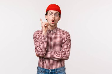 Bir fikrim var, dinle beni. Yaratıcı heyecanlı genç erkek iş arkadaşı düşüncelerini paylaşıyor, Eureka jestinde işaret parmağını kaldırıyor ekibe hitap ediyor, harika bir plan yapıyor, beyaz arka planda duruyor.