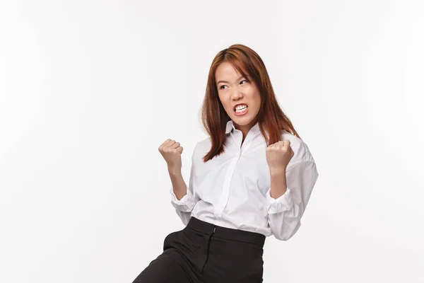 Girl power. Satisfied and pleased asian woman feeling like fighter, winning competition, fist pump and look relieved pleased, achieve goal, become winner, receive prize or reward, white background — Stock Photo, Image