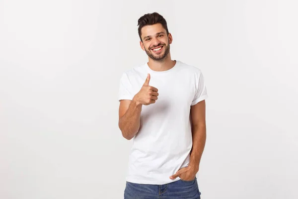 Jovem homem feliz com polegares para cima sinal em baixas isoladas no fundo branco — Fotografia de Stock