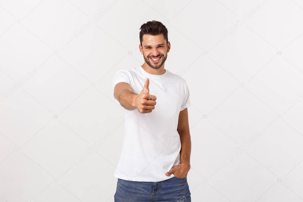 Young happy man with thumbs up sign in casuals isolated on white background