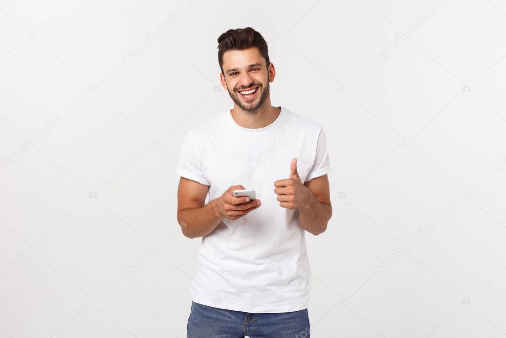 Happy casual man with smartphone and thumb up over gray background