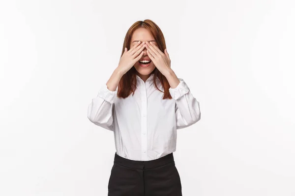 Portrait of excited upbeat smiling asian woman waiting for her surprise, counting ten to open eyes as standing blindfolded on b-day party friends bring gift, standing white background