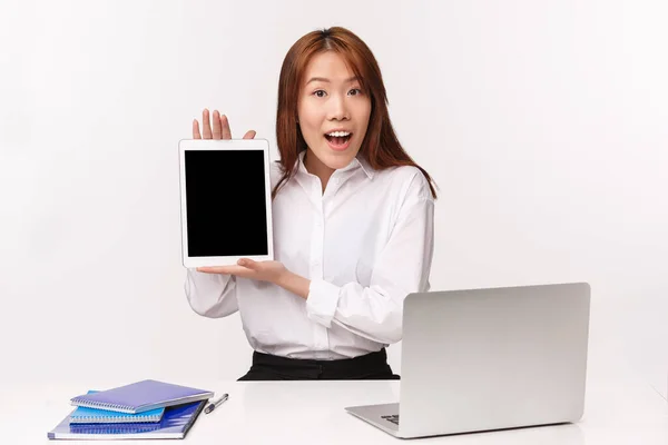 Career, work and women entrepreneurs concept. Close-up portrait of professional young enthusiastic office lady, manager introducing her project on tablet, showing display, white background