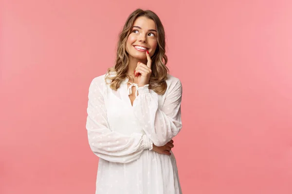 Conceito de beleza, moda e mulheres. Retrato de feminino, linda menina loira em vestido branco, imagem algo romântico e interessante, sorridente olhar para cima pensativo, ter plano, tomar a decisão — Fotografia de Stock