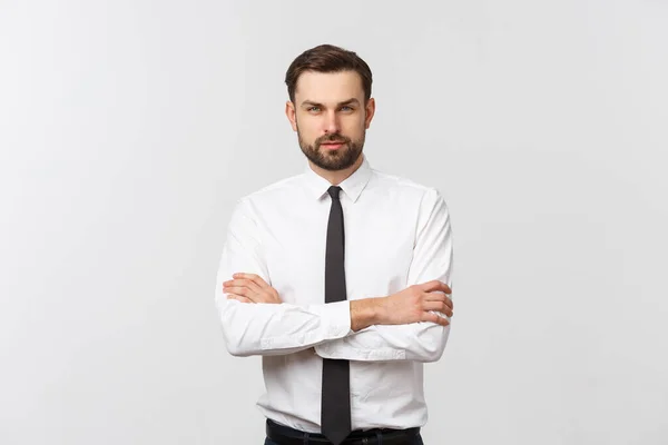 Portrait of a confident young businessman with crossing arms on white background — Stock Photo, Image