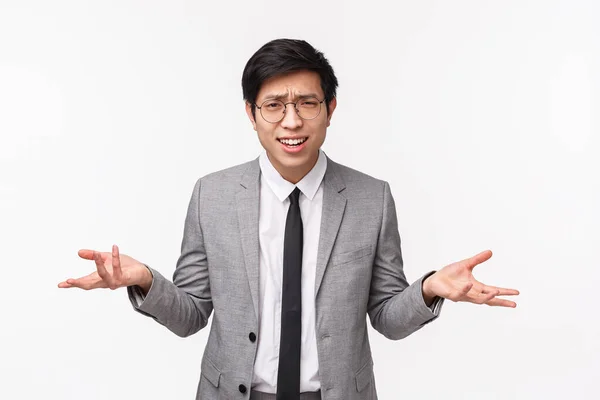 Why what do you want. Waist-up portrait of bothered and frustrated young asian man in grey suit being disappointed and upset with someone saying nonsense, strange accusations — Stock Photo, Image