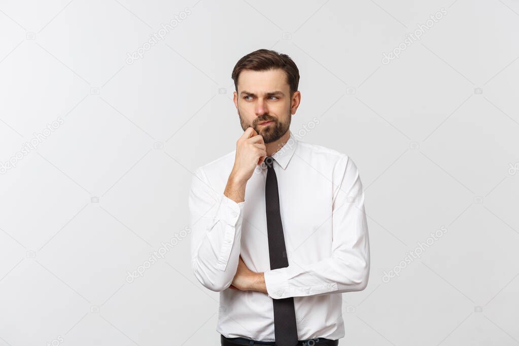 Thinking man isolated on white background. Closeup portrait of a casual young pensive businessman looking up at copyspace. Caucasian male model