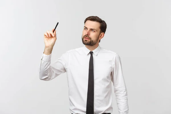 Een blik op een jonge zakenman met een pen, klaar om iets te schrijven, geïsoleerd op witte achtergrond — Stockfoto