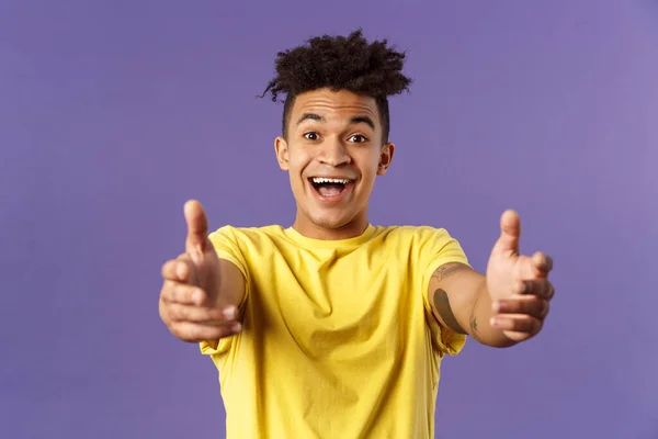 Close-up portrait of charismatic, happy friendly-looking hispanic man with dreads reaching hands forward to hold something, give hug or cuddle dearly, standing purple background — Stock Photo, Image