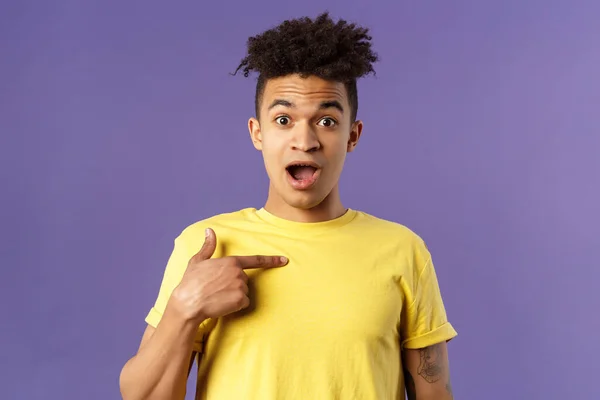 Who me, no way. Portrait of surprised, happy rejoicing young man looking with disbelies as being chosen from all candidates, pointing at himself open mouth fascinated, purple background — Stock Photo, Image