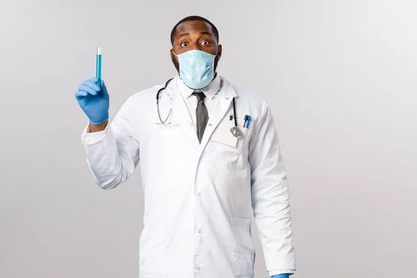 Covid-19, coronavirus 환자 치료 및 질병 개념. 얼굴 마스크와 라텍스 장갑을 착용하고 백신을 장착 한 아프리카 계 미국인 남성 의사, 실험실에서 발명 된 치료제 — 스톡 사진