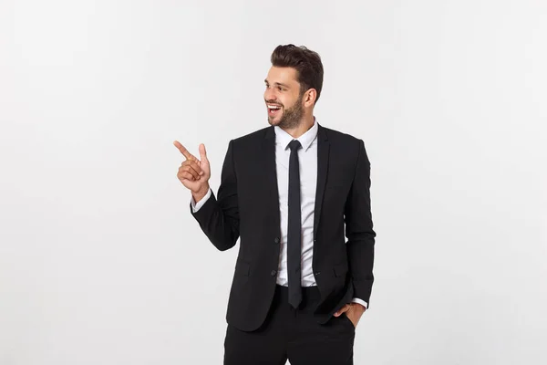Portret van jonge zakenman in pak wijzend op kopieerruimte over witte achtergrond. — Stockfoto