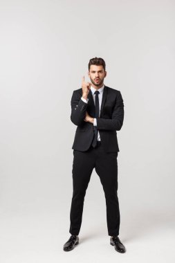 Beyaz arka planda izole edilmiş kameraya bakan yakışıklı iş adamı ya da model portresi