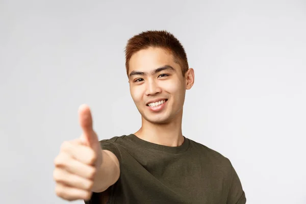 People, different expressions and lifestyle concept. Great idea, nice work. Portrait of enthusiastic asian male student found good part-time jow, recruit young people apply for job, show thumbs-up — Stock Photo, Image