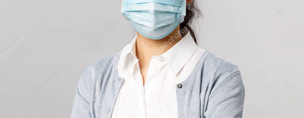 Covid19, virus, health and medicine concept. Portrait of young asian woman wearing medical face mask to prevent getting infected by coronaviruts, staying safe home during quarantine, pandemia