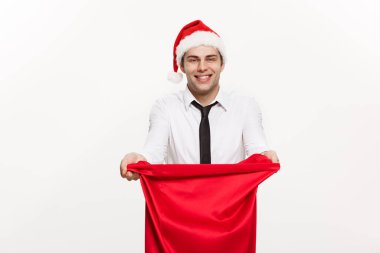 Noel Kavramı - Yakışıklı İş adamı Mutlu Noeller kutlar ve Noel Baba kırmızı büyük çantalı şapka giyer.