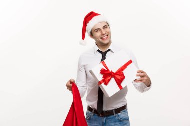 Noel Kavramı - Yakışıklı İş adamı Mutlu Noeller kutlar ve Noel Baba kırmızı büyük çantalı şapka giyer.