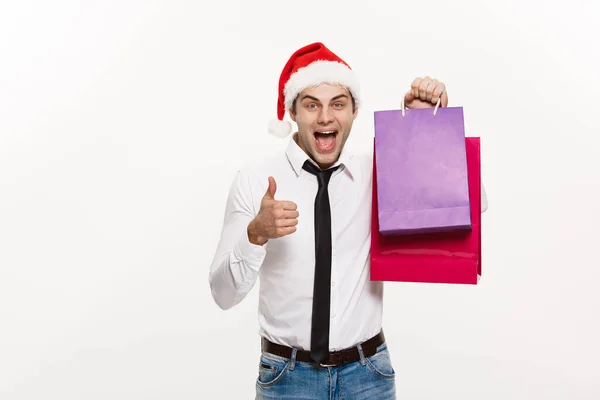 Conceito de Natal - Bonito homem de negócios comemorar Feliz Natal e feliz ano novo usar chapéu de Papai Noel com saco grande vermelho . — Fotografia de Stock