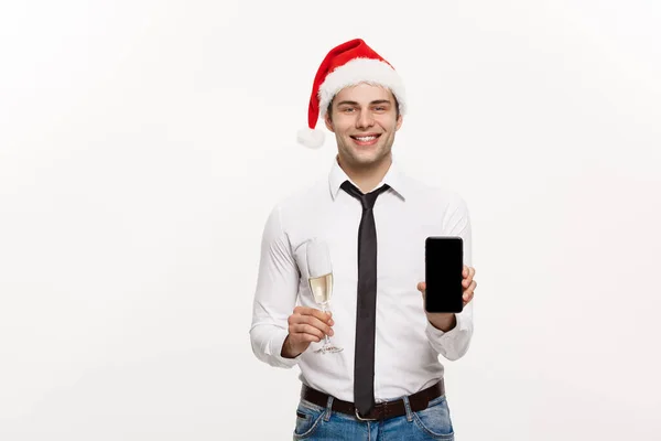 Christmas Concept - Handsome Business man talking on phone and holding glass of champange celebrating Chirstmas and New year.