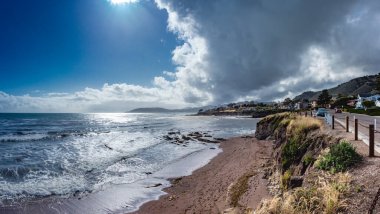 Pasifik Okyanusu boyunca bulutlar, setler ve küçük şehir Pismo Beach, California, ABD