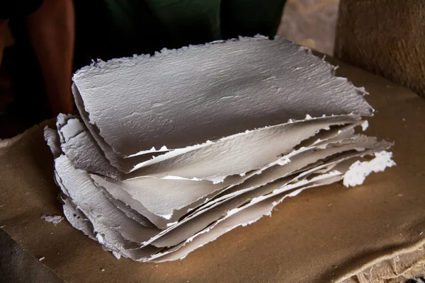 Stack of paper sheets in an ancient paper mill. Old traditional