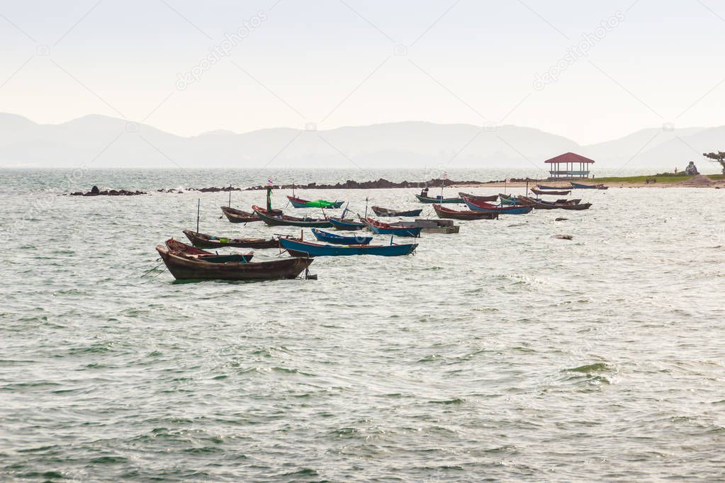 Beautiful sea, sand and fishing boats with mountain and blue sky