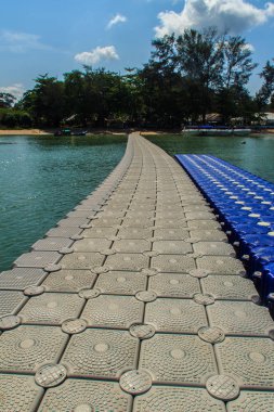 Beautiful gray pontoon made from plastic floating in the sea, rotomolding jetty, a landing stage or small pier at which boats can dock or be moored, floating pier clipart