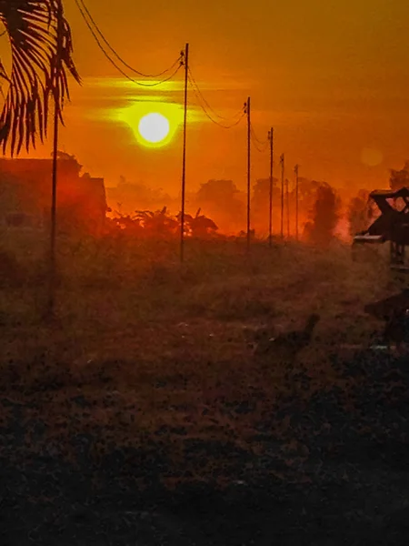 The Rural Area in the Morning with sunrise background and foreground with electric cables. This is for the electricity and country development concept.