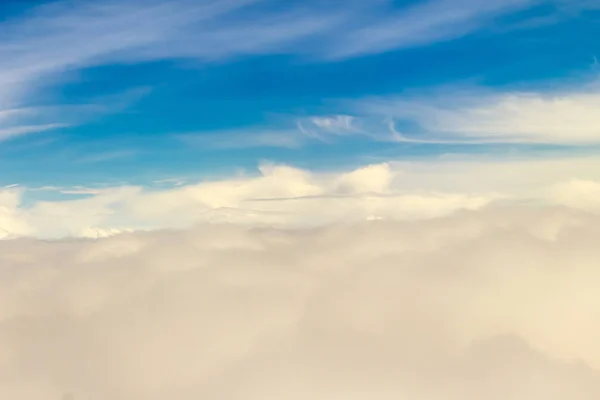 Beautiful cloudscape from sky aerial view. Beauty of nature view from above the sky and clouds. White clouds and blue sky view from airplane window. Sunlight in the sky shines on clouds.