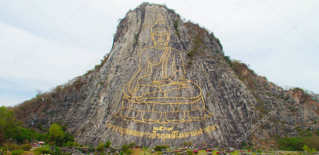 Golden Buddha laser carved and inlayed with gold on Khao Chee Chan Cliff. One of most famous landscape located in Sattahip, Chonburi province, Thailand.