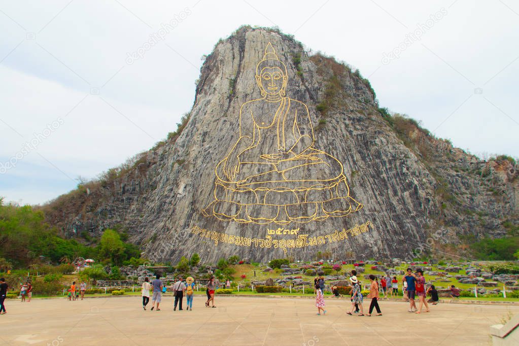 Golden Buddha laser carved and inlayed with gold on Khao Chee Chan Cliff. One of most famous landscape located in Sattahip, Chonburi province, Thailand.