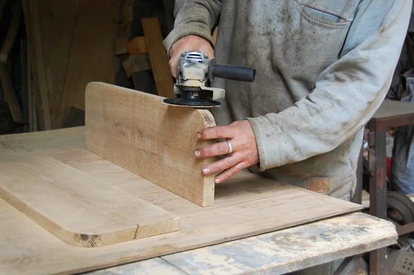 Carpenter polishing a wooden surface, hand and electrical polisher, — Stock Photo, Image