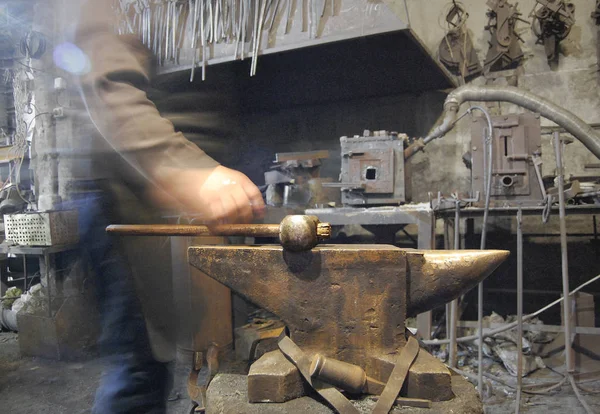 Blacksmith body, anvil with hammer on it in forge — Stock Photo, Image