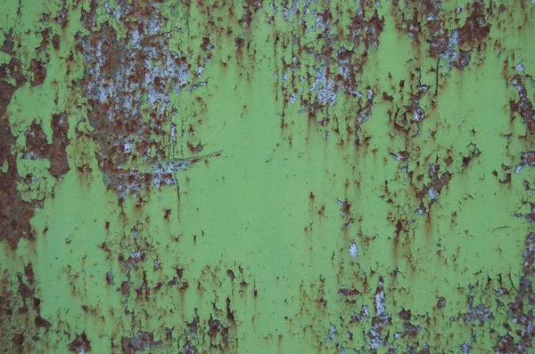 锈迹斑斑的背景上的旧的破裂的油漆图案。剥落绿色的磨碎材料. — 图库照片