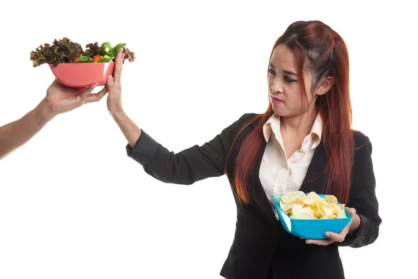 Jonge Aziatische vrouw met aardappel chips nee zeggen tegen salade. — Stockfoto