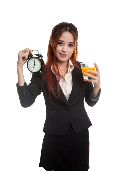 Asian woman with a clock drink orange juice. — Stock Photo, Image