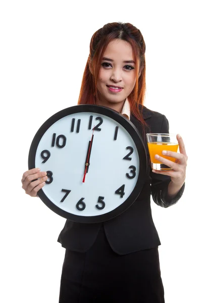 Asian woman with a clock drink orange juice. — Stock Photo, Image