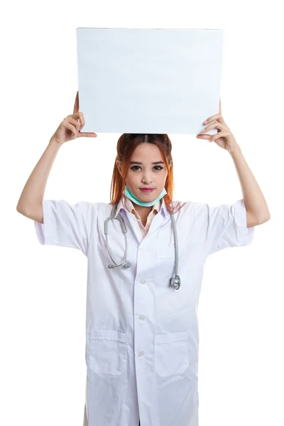 Joven asiática médico muestra un signo en blanco sobre la cabeza . — Foto de Stock