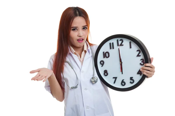 Angry Young Asian female doctor with a clock. — Stock Photo, Image