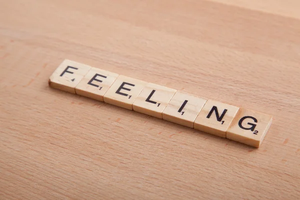 Scrabble betűk írásmódját a word érzés. — Stock Fotó