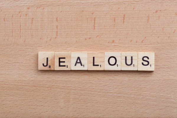 Scrabble letters spelling the word Jealous.