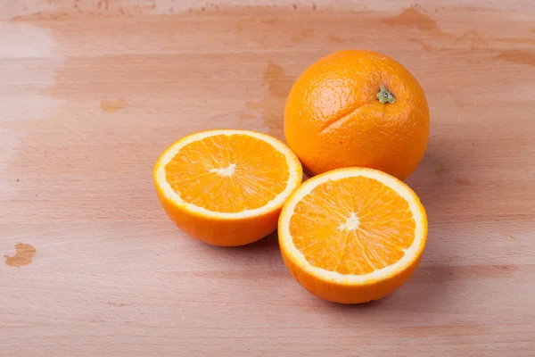 Half cut Orange on wooden table — Stock Photo, Image