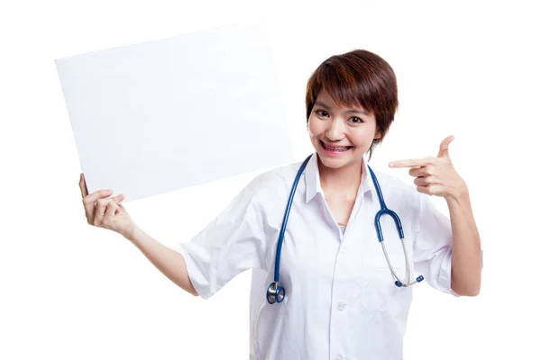 Young Asian female doctor point to a blank sign. — Stock Photo, Image