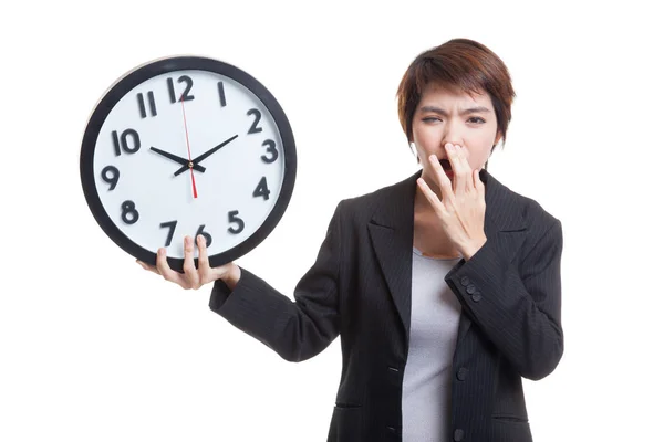 Sleepy young Asian business woman with a clock in the morning. — Stock Photo, Image