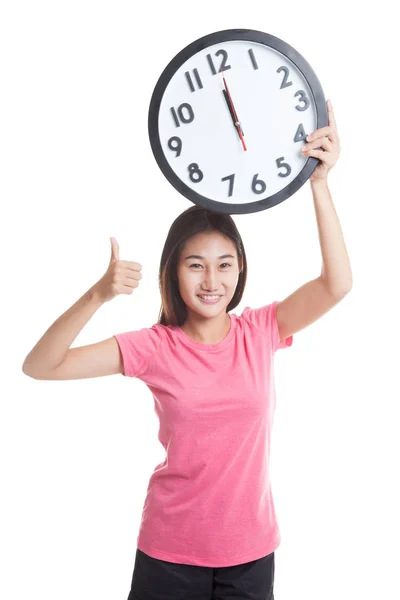 Young Asian woman thumbs up with a clock. — Stock Photo, Image