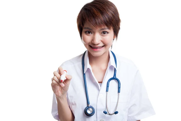 Young Asian female doctor with a red marker. — Stock Photo, Image