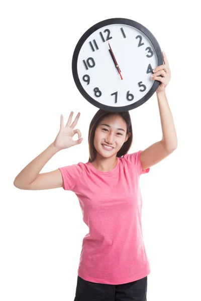 Junge asiatische Frau zeigen ok mit einer Uhr. — Stockfoto