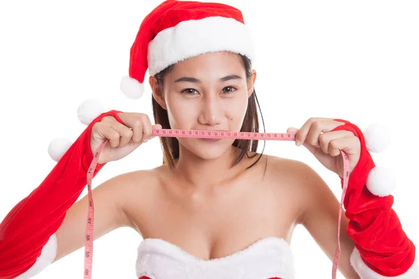 Asiatique Noël Père Noël fille alimentation avec ruban à mesurer . — Photo