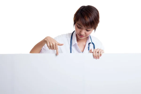 Young Asian female doctor point and look down to blank sign. — Stock Photo, Image